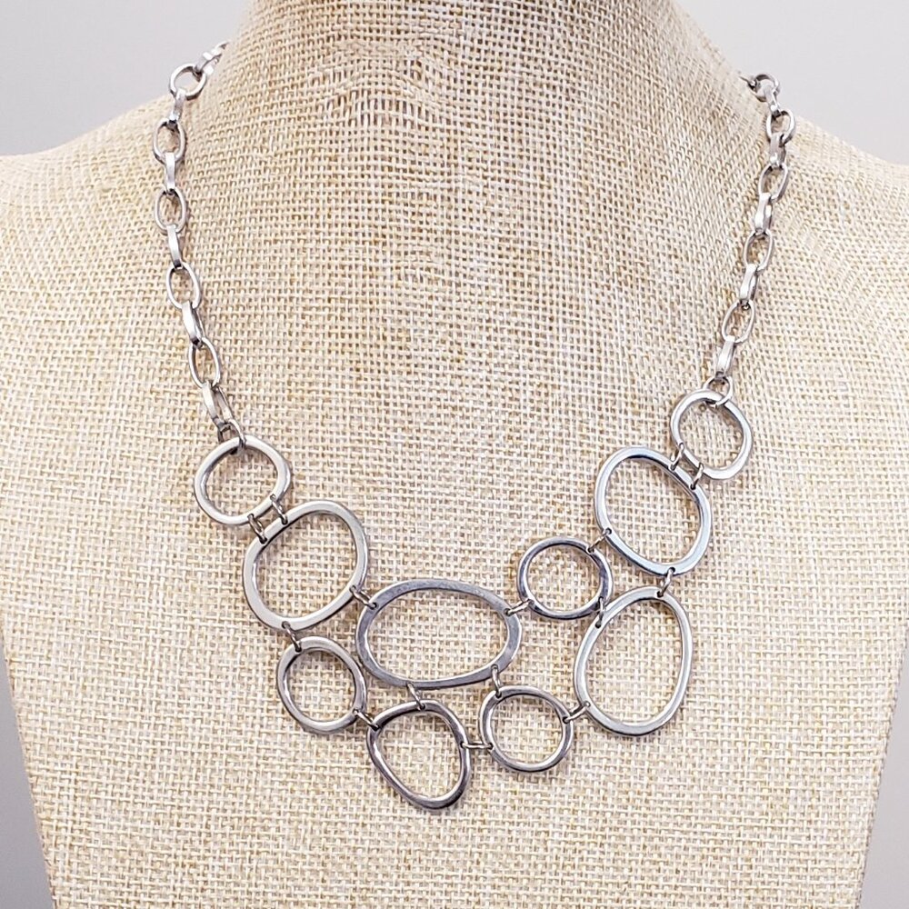 Silver tone, open circular pattern statement fashion necklace